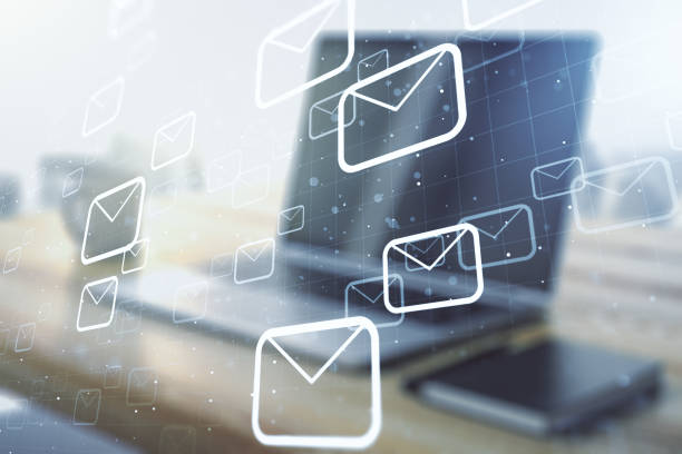 istock Creative concept of postal envelopes illustration and modern desktop with computer on background. Email and communications concept. Multiexposure 2184114568