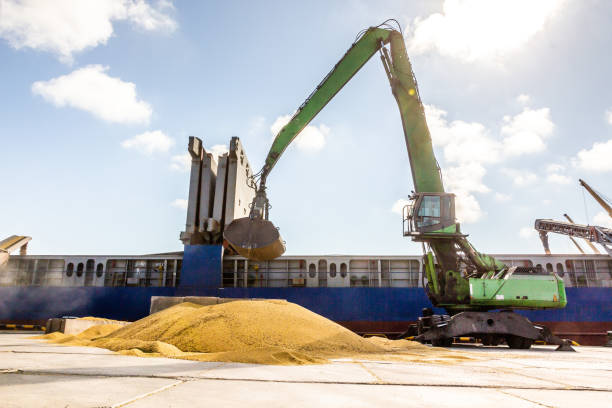 istock A green grapple manipulator picks up a load of corn and carries it into the ships hold 2184114919