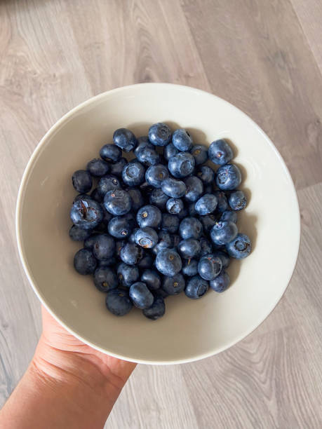 istock Fresh blueberries in white plate close-up, background 2184116074