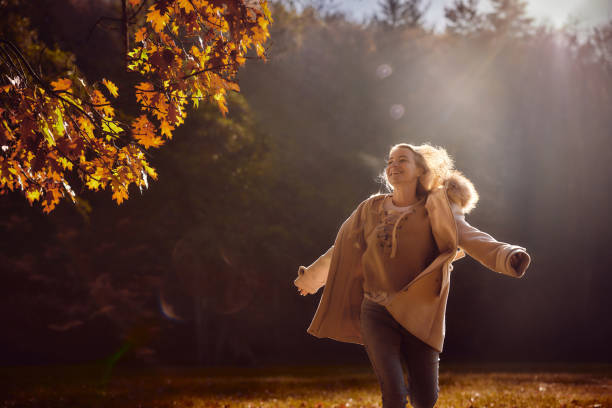 istock Playful woman having fun while running in autumn day. 2184116081