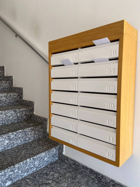 istock Row of mailboxes in a modern apartment building, with letters sticking out, symbolizing communication and daily life. Blend of functionality and design, capturing the essence of urban living 2184116420