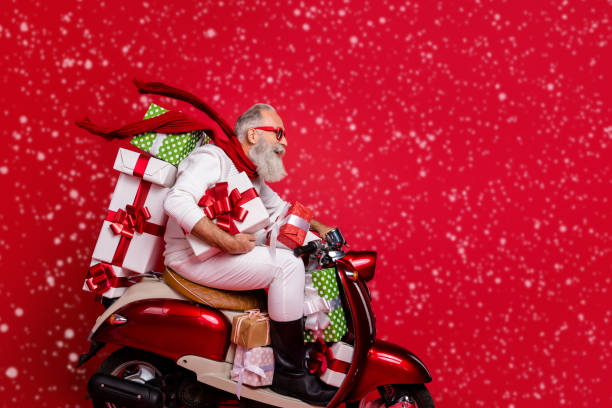 istock Profile side view of nice attractive funky cheery bearded gray-haired man riding motor carrying pile stack new desirable purchase package air wind blowing isolated on bright vivid shine red background 2184116493