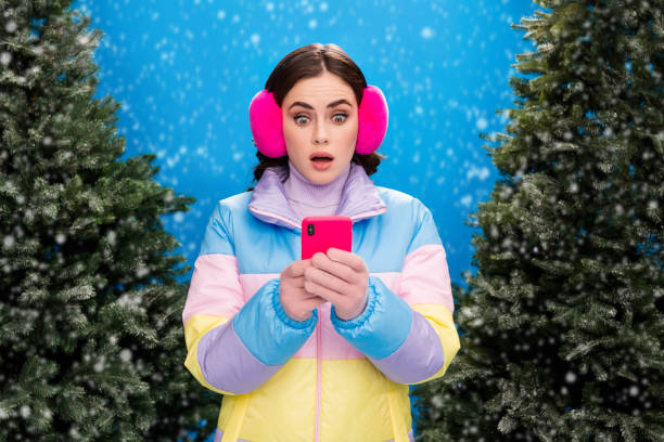 istock Photo of charming worried nervous afraid scared lady use device oops mistake problem walking street outside evergreen pine tree market 2184118141