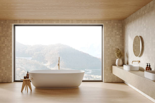 istock Beige tile hotel bathroom interior with sink and bathtub, panoramic window 2184118455