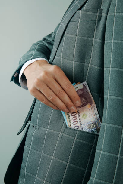 istock businessman puts some forints into his pocket 2184118552