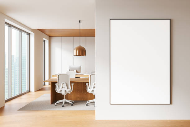 istock White meeting interior desk with pc desktop and board near window. Mockup frame 2184118869