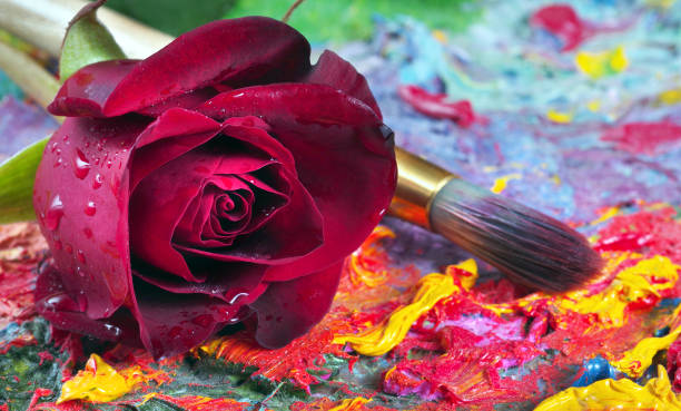 istock beautiful red rose and brush on artist's palette 2184119631