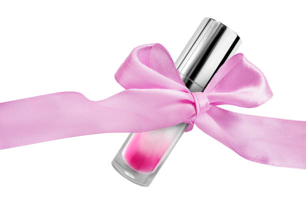 Pink lip gloss tube tied with pink satin ribbon bow isolated over white