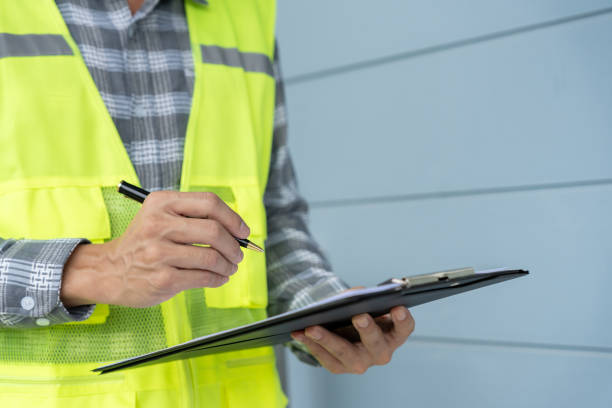 istock inspector or engineer is inspecting construction and quality assurance new house using a checklist. Engineers or architects or contactor work to build the house before handing it over to the homeowner 2184119940