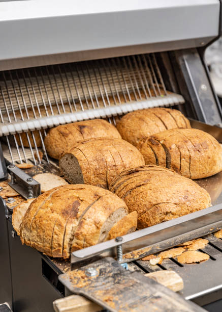 istock Sourdough bread slicing in industrial bread slicing machine 2184121361