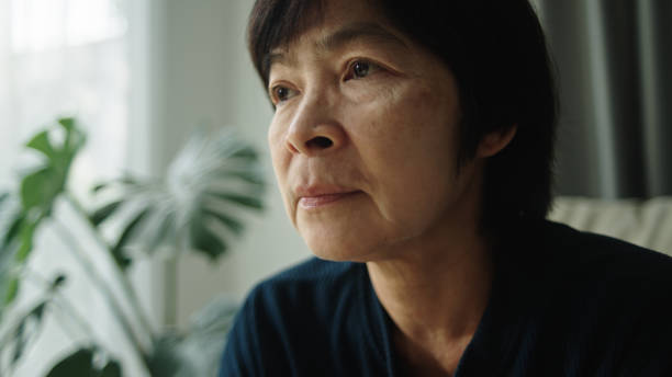 istock Mature woman contemplation on sofa. 2184122132