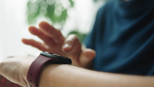 istock Mature woman using smartwatch at home. 2184122709