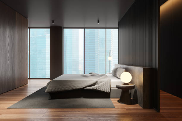 istock Dark minimalist home bedroom interior with bed and decor, panoramic window 2184122721