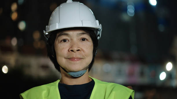 istock Portrait of engineer woman on construction site at night. 2184122773