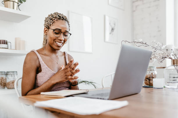 istock Young Professional Woman Working Remotely on Laptop at Home 2184123273