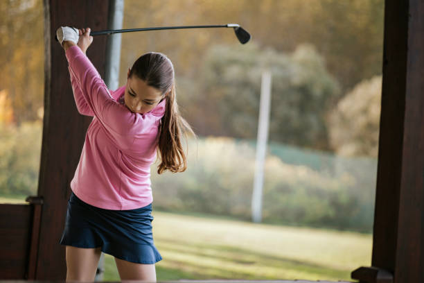 istock Young woman practicing golf swing in a serene outdoor setting 2184125331