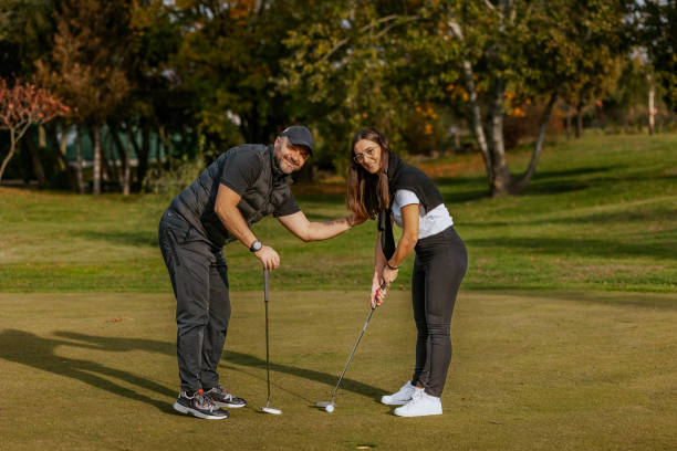 istock Golf lesson in a sunny park with instructor and student 2184125633