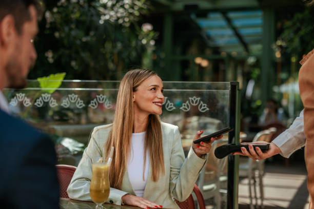 istock Woman paying by phone at payment terminal 2184125969