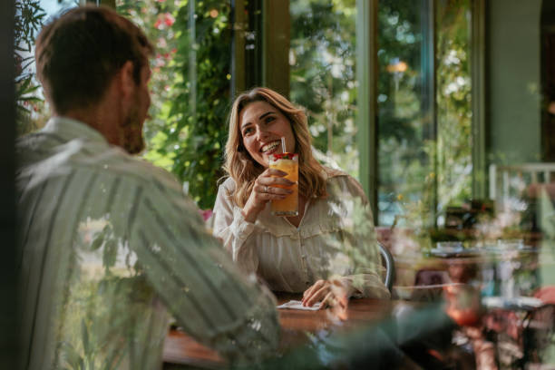 istock Blonde woman talking to a man on a date 2184125977