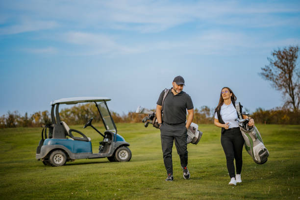 istock Couple arriving at golf course ready for a day of practice 2184126319