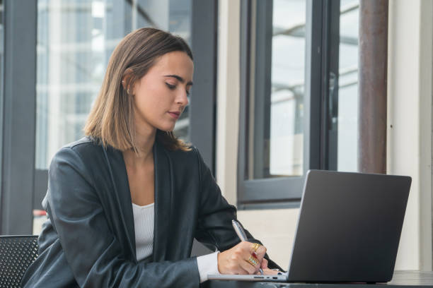 istock Financial adviser and investor on the phone while consulting data on a laptop computer 2184126333