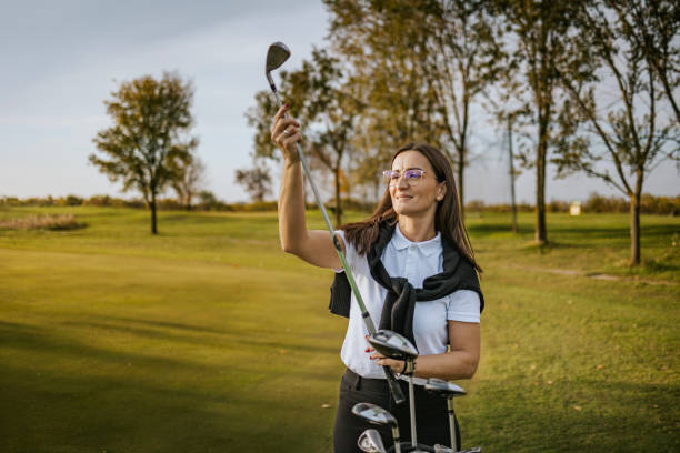 istock Woman on golf course choosing the right club for her game 2184126625
