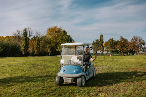 Valmiera, Latvia - October 18, 2024 - A golf cart parked on a frosty golf course at sunrise, with golden light casting long shadows across the grassy landscape.