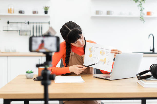 istock Young woman presenting analysis during online video session 2184129815
