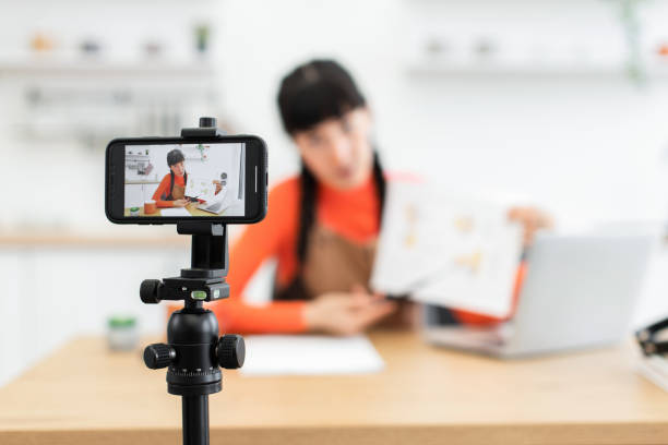 istock Caucasian female influencer creating content in bright home setting 2184129827