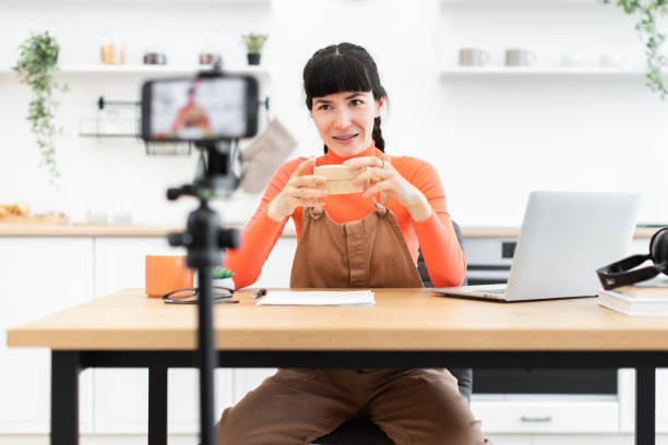 istock Caucasian female blogger unpacking items in modern home studio 2184129868