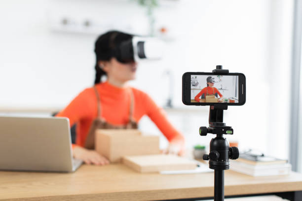 istock Caucasian female blogger unboxing virtual headset during live stream 2184130002
