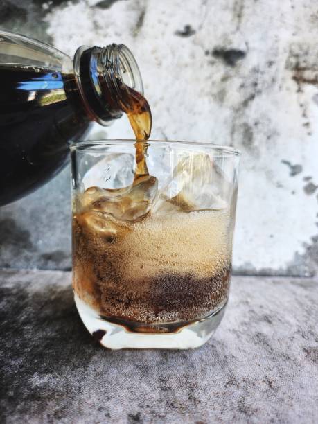 istock Pouring cola drink with ice cubes 2184130366