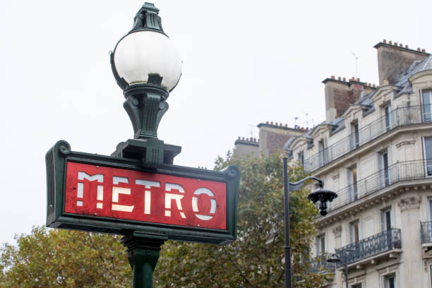 istock Paris metro sign and city buildings 2184130664