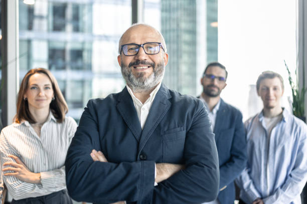 istock Confident Business Team Standing Together in Modern Office 2184132035