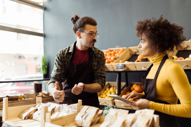 istock Man and woman working in grocery store 2184133819