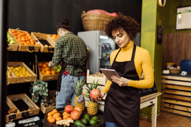 istock Man and woman working in grocery store 2184134433