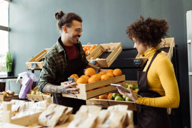 istock Man and woman working in grocery store 2184134452