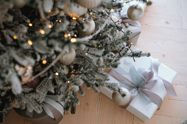 istock Christmas tree with decorated branches and beautifully wrapped gifts beneath it 2184135636