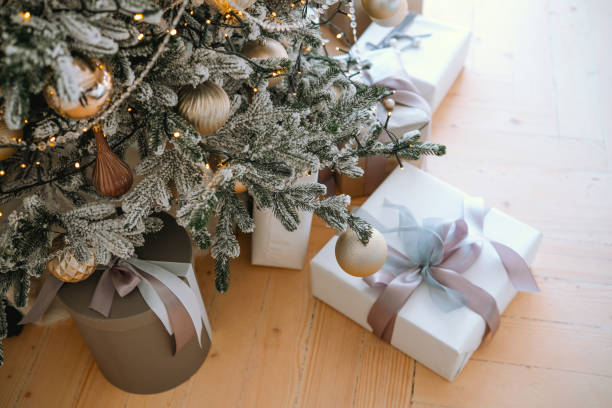 istock Decorated Christmas tree with presents under it in a cozy living room 2184135640