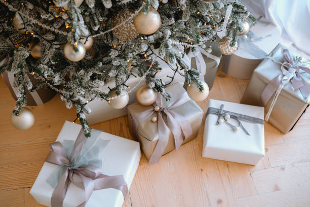 istock Gifts elegantly wrapped under a beautifully decorated Christmas tree 2184135643