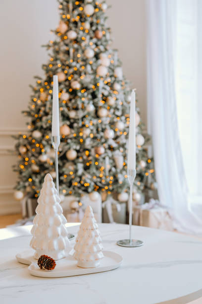 istock Elegant holiday decorations with a Christmas tree and candles in a cozy setting 2184135664