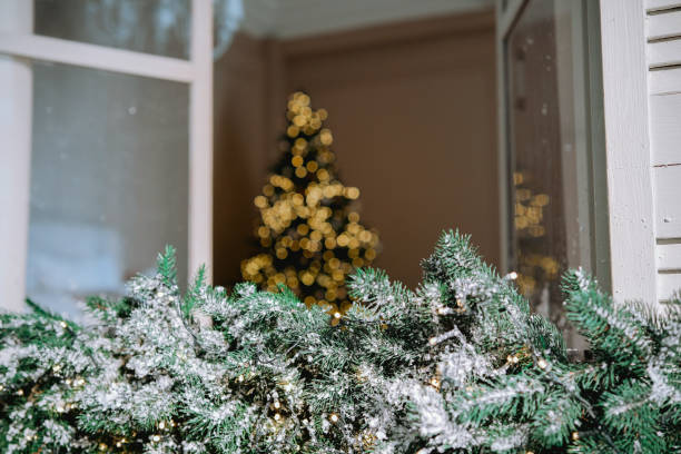 istock Cozy holiday setting featuring a decorated Christmas tree with lights in winter 2184135694