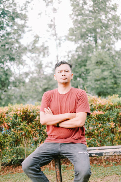 istock Southeast Asian man folding his arms with a calm expression. 2184136098