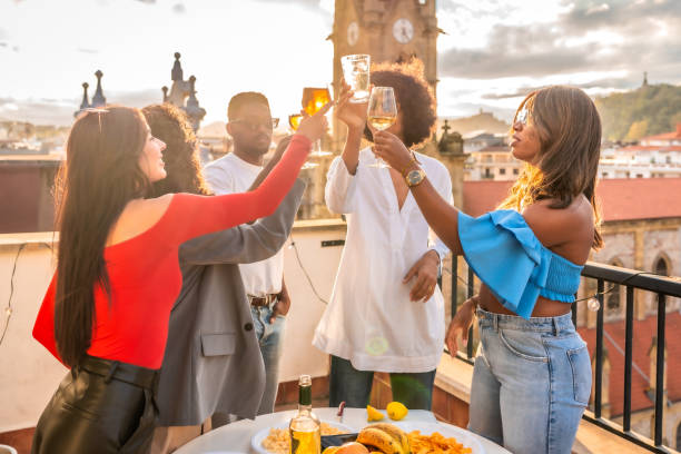 istock Multi-ethnic friends toasting celebrating a roof evening meal 2184137335
