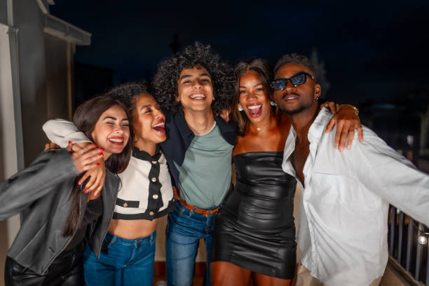 istock Friends embracing from the shoulder partying at night 2184137547