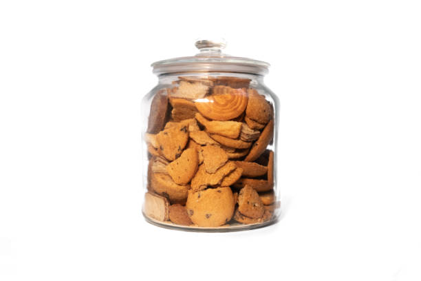 istock Glass jar full of assorted biscuits on a pure white background 2184139157