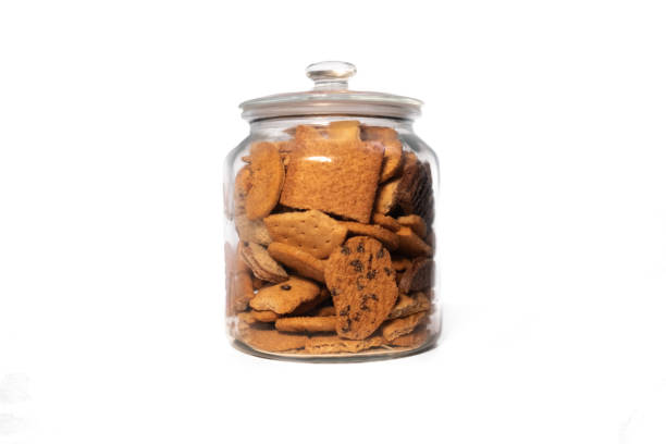 istock Glass jar full of assorted biscuits on a pure white background 2184139237