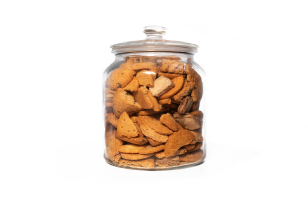 istock Glass jar full of assorted biscuits on a pure white background 2184139303