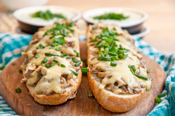 casserole with cheese and mushrooms sprinkled with fresh chive with tzatziki sauce
