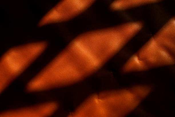 istock shadows on brown leather. the sunlight coming in through the window creates shadows on brown leather. 2184142963